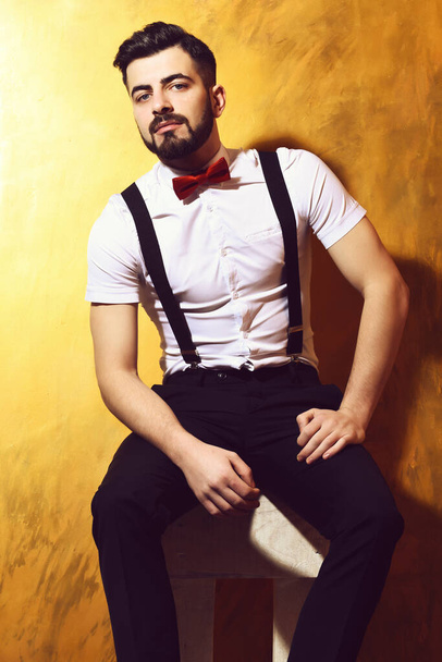 bearded man sitting on chair with serious face - Zdjęcie, obraz