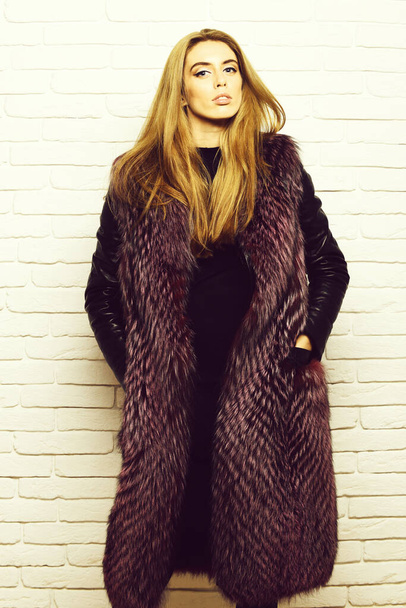 fashionable sexy woman in fur on white brick wall studio background - Fotografie, Obrázek