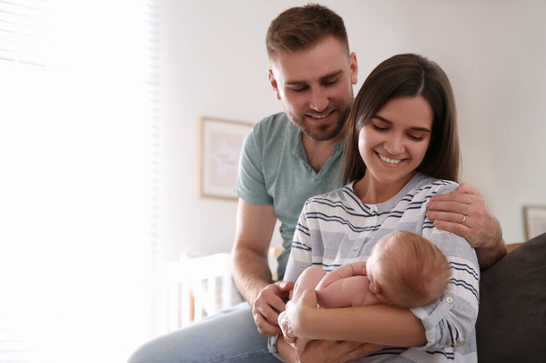 Happy couple with their newborn baby at home - Photo, Image