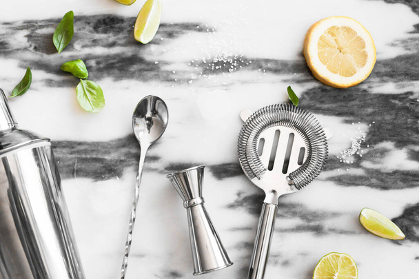 A set of cocktail tools, lime, lemon, sugar, ice, ingredients for ,top view, marble background  - Photo, Image