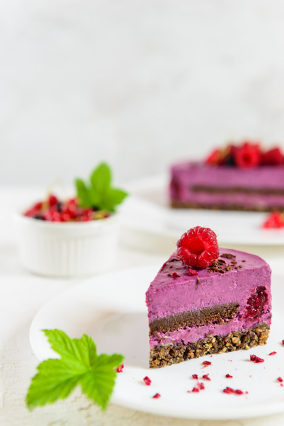 A slice of raw cashew cake made from black currant, chocolate and green buckwheat granola. Sugar, lactose, gluten free. - Photo, Image