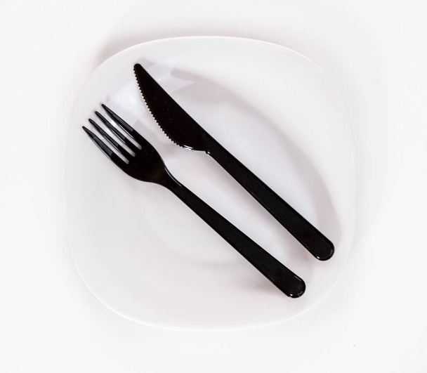 Black plastic fork and knife isolated on white background. - Fotoğraf, Görsel