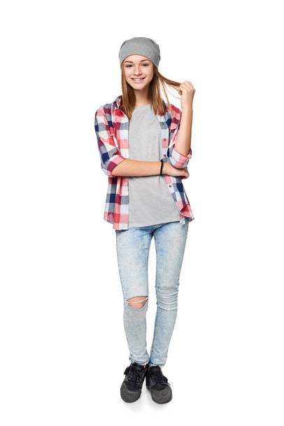 Smiling relaxed teen girl standing in full length, looking at camera, studio portrait - Fotoğraf, Görsel