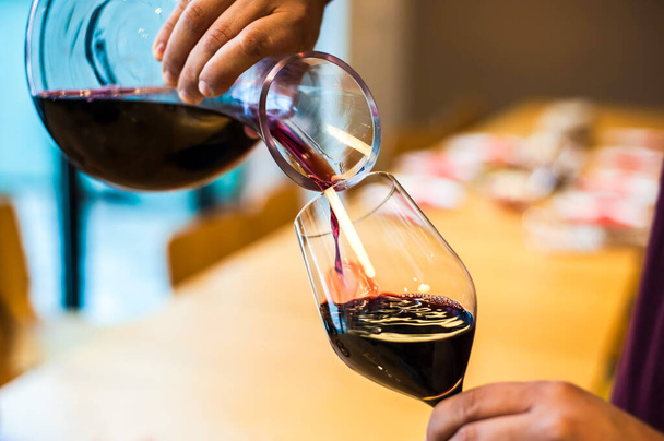 Close Up Of Red Wine Being Poured Into A Wine Glass - Photo, Image