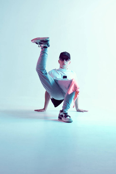 Cool young breakdancer guy dancing hip-hop in neon light. Dance school poster. Battle competition announcement - Фото, изображение