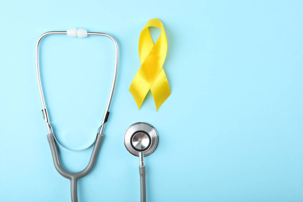 yellow ribbon symbolizing cancer in children top view - Фото, изображение