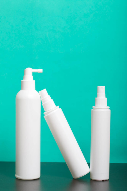 Sprayers with antiseptic, white. For surface treatment against viruses. Against a mint background. - Фото, зображення