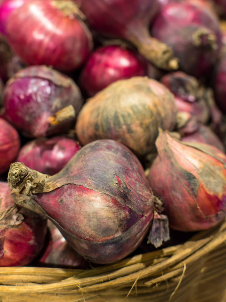 Closeup of Red onions for sale at the vegetable section of the supermarket. - Фото, изображение