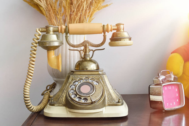 Teléfono vintage sobre fondo de mesa de madera. Teléfono antiguo rotatorio. - Foto, imagen
