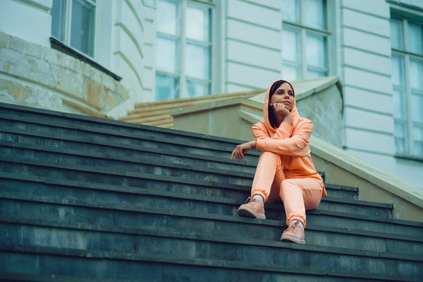 Adult female sitting on steps of Palace. - Фото, зображення