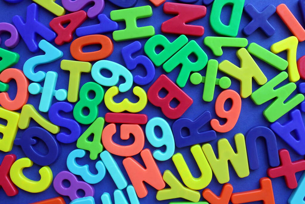 Multicolored letters and numbers on a blue background - Φωτογραφία, εικόνα