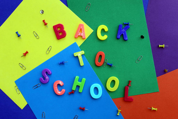 Inscription on a multi-colored surface `back to school` - 写真・画像