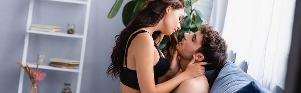 website header of woman touching muscular man in bedroom  - Foto, Bild
