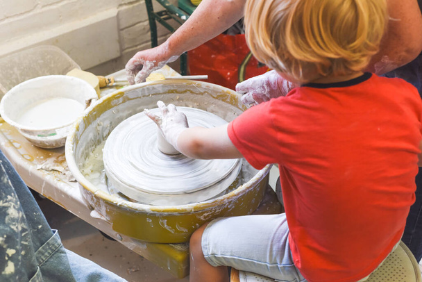 Children making pottery during ceramic lesson with clay - Photo, Image