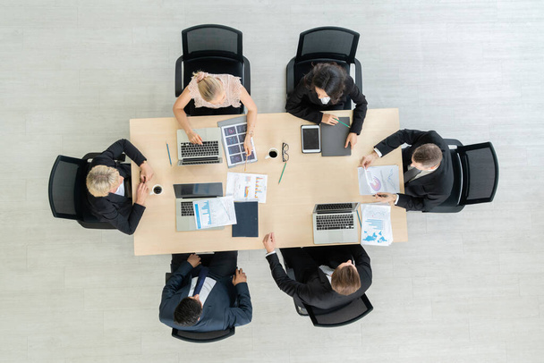 Business people group meeting shot from top view in office . Profession businesswomen, businessmen and office workers working in team conference with project planning document on meeting table . - Foto, immagini