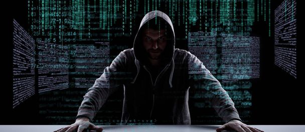 Hacker prints a code on a laptop keyboard to break into a cyberspace - Photo, Image