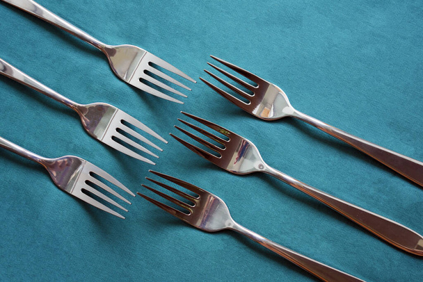 six metal forks on green background - Fotó, kép