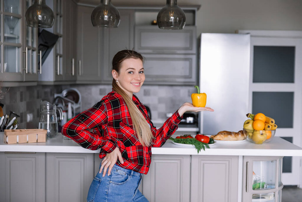 model advertises healthy lifestyle holding yellow pepper in her hands - 写真・画像