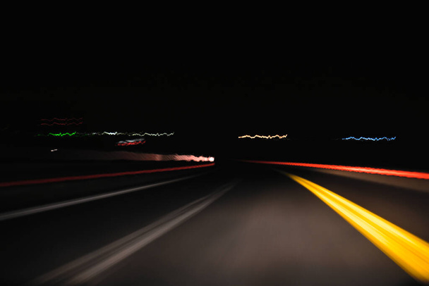 The motorway at night is photographed with a long exposure. Abstraction of the night road. - Photo, Image