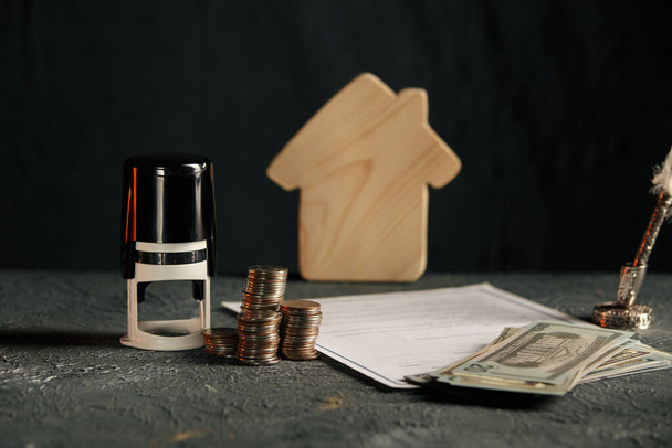 Miniature house with money and tax papers - Photo, Image