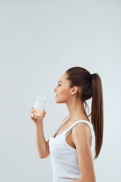 Portrait Of Happy Smiling Young Woman With Glass Of Fresh Water. Healthcare. Drinks. Health, Beauty, Diet Concept. Healthy Lifestyle Eating.  - Zdjęcie, obraz