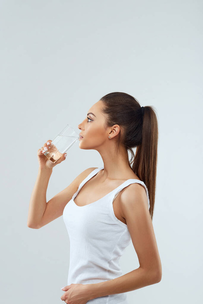 Drink Water. Portrait Of Beautiful Healthy Girl With Beauty Face Drinking Fresh Water In Morning.Young Woman With Glass Of Water. Diet Concept - Zdjęcie, obraz
