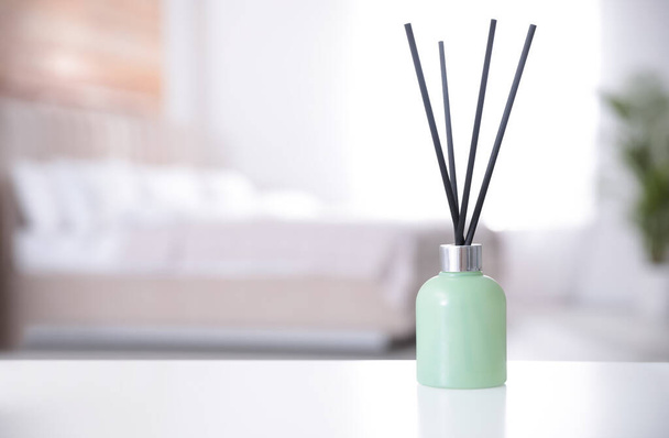 Reed air freshener on white table indoors. Space for text - Zdjęcie, obraz