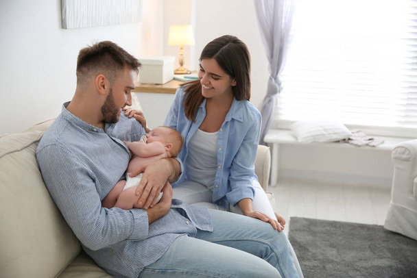Happy couple with their newborn baby at home - Foto, Imagen
