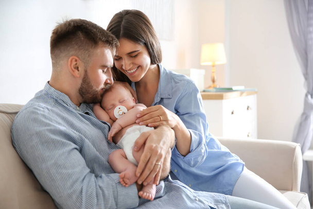 Happy couple with their newborn baby at home - 写真・画像