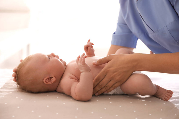 Doctor examining cute baby in clinic, closeup. Health care - Photo, Image