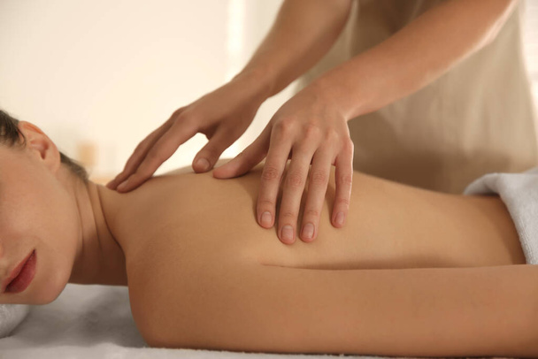Young woman receiving back massage in spa salon, closeup - Fotografie, Obrázek