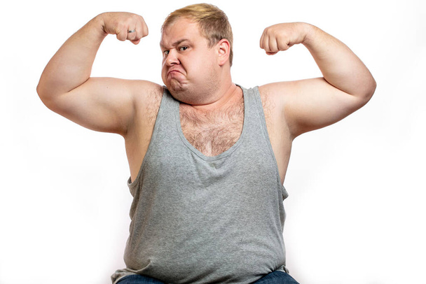 Funny overweight sports man flexing his muscle isolated on white background - Photo, Image