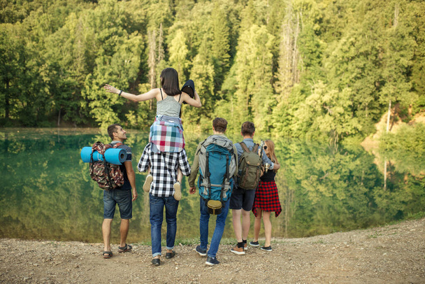 young active hikers are standing next to the river - Foto, Bild
