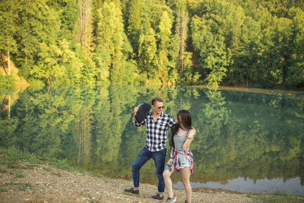 young joyful people are strolling on the lakeside - Zdjęcie, obraz