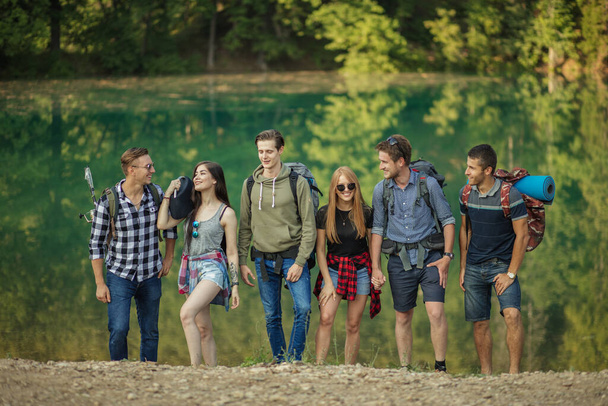 happy teenagers are going home after interesting days off in the nature - Фото, изображение