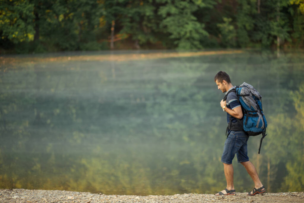 Full length portrait of a handsome hiker with backpack - Fotografie, Obrázek