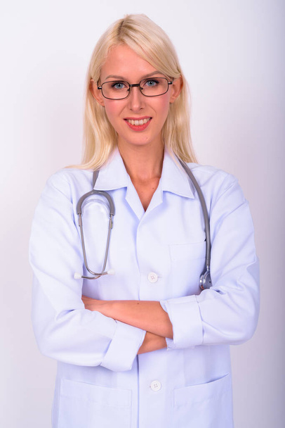 Studio shot of young beautiful woman blonde doctor with eyeglasses against white background - Photo, image