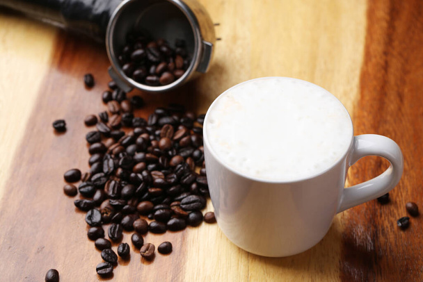 Hot latte , hot coffee and milk foam on wood floor - Foto, immagini