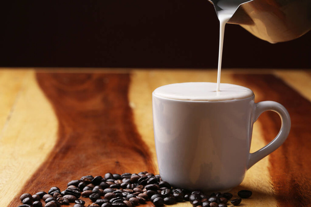 Hot latte , hot coffee and milk foam on wood floor - Foto, Bild