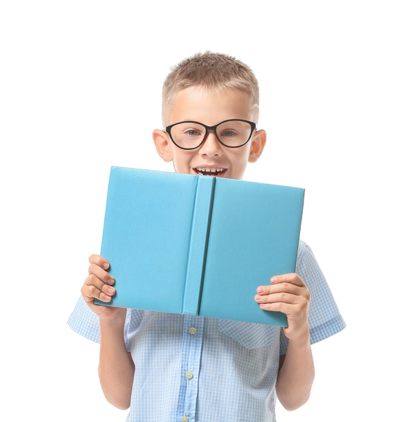 Cute little boy with book on white background - Photo, Image