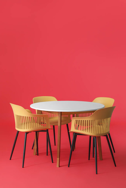 Dining table with chairs on color background - Photo, Image