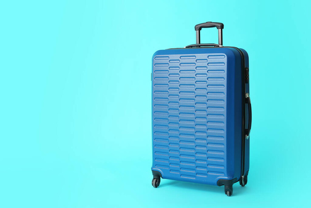 Packed suitcase on color background. Travel concept - Фото, изображение