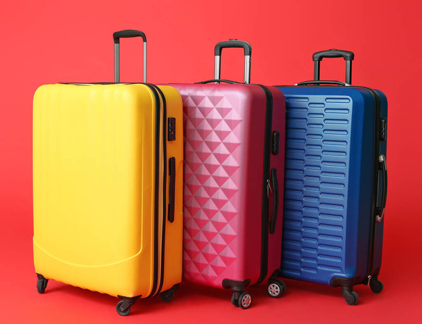 Packed suitcases on color background. Travel concept - 写真・画像