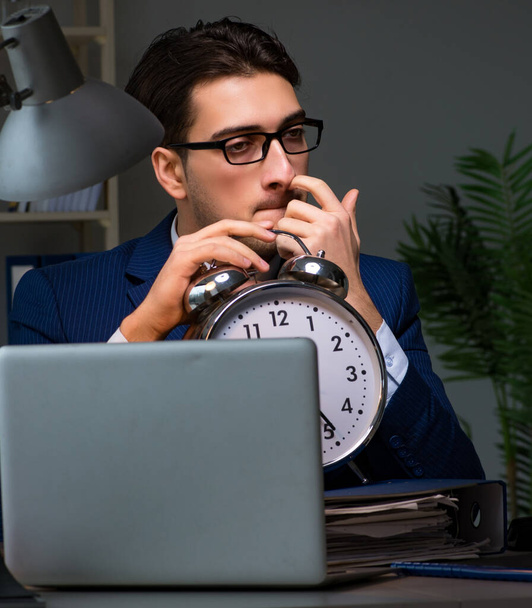 Employee staying late to finish work on auditing - Photo, Image