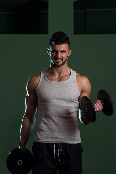 Muscular Man Exercising Biceps - 写真・画像