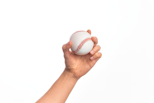 Hand of caucasian young man holding baseball ball over isolated white background - Photo, Image