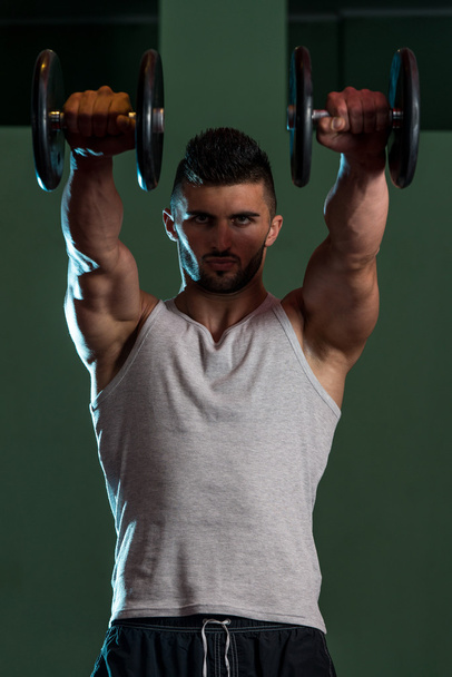 Muscular Men Exercising Shoulder With Dumbbells - Fotoğraf, Görsel