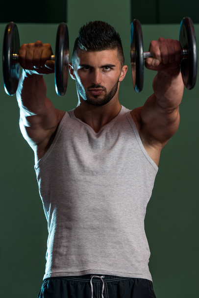 Muscular Men Exercising Shoulder With Dumbbells - Fotoğraf, Görsel