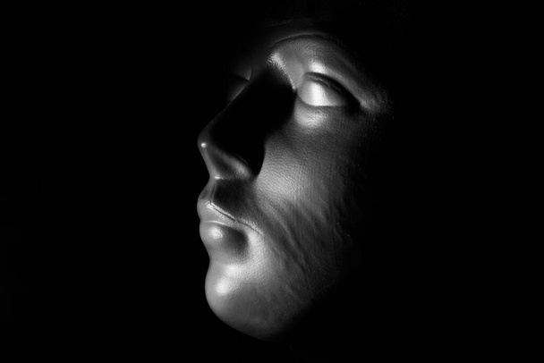 close up picture of a white plastic mannequin head on a black background - Fotó, kép