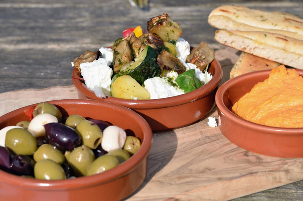 Mediterranean antipasti style healthy food with cheese, black and green olives. - Photo, Image